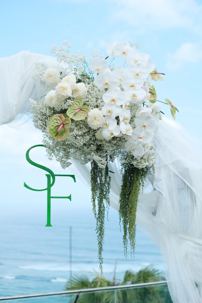 floral altar arch ocean backdrop