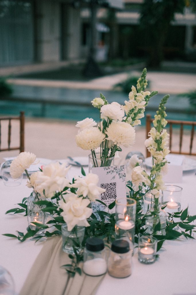 Sage linen reception table with floral centerpiece