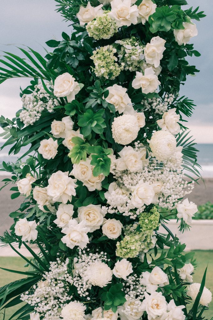 White roses and baby's breath ceremony arch
