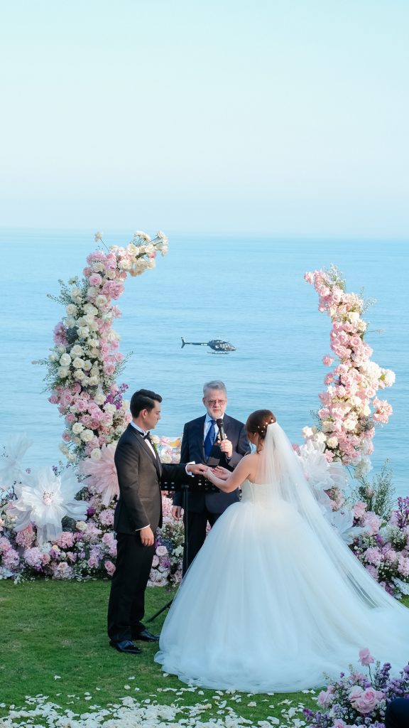 [Blush wedding decor against deep blue ocean]