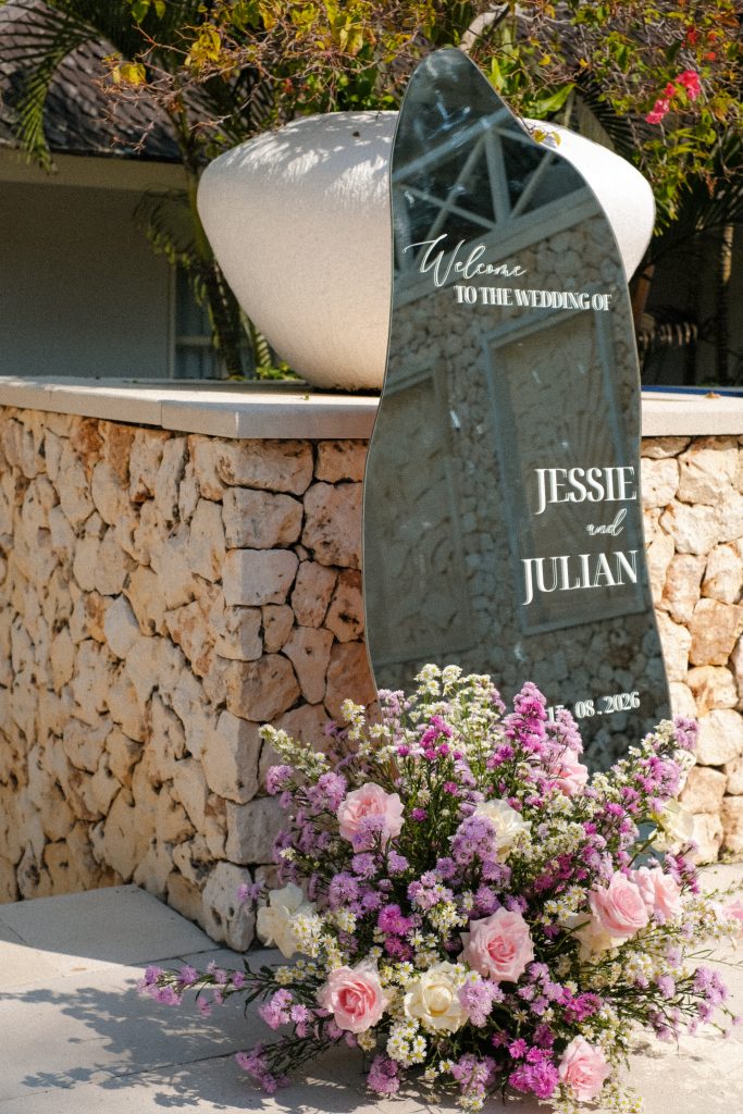 [Fluid glass welcome sign with flowers]