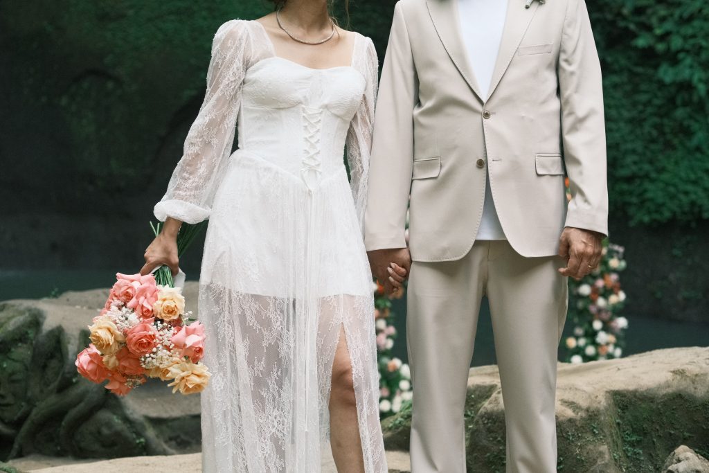 Bride holding hand-tied bouquet filled with fresh bali waterfall