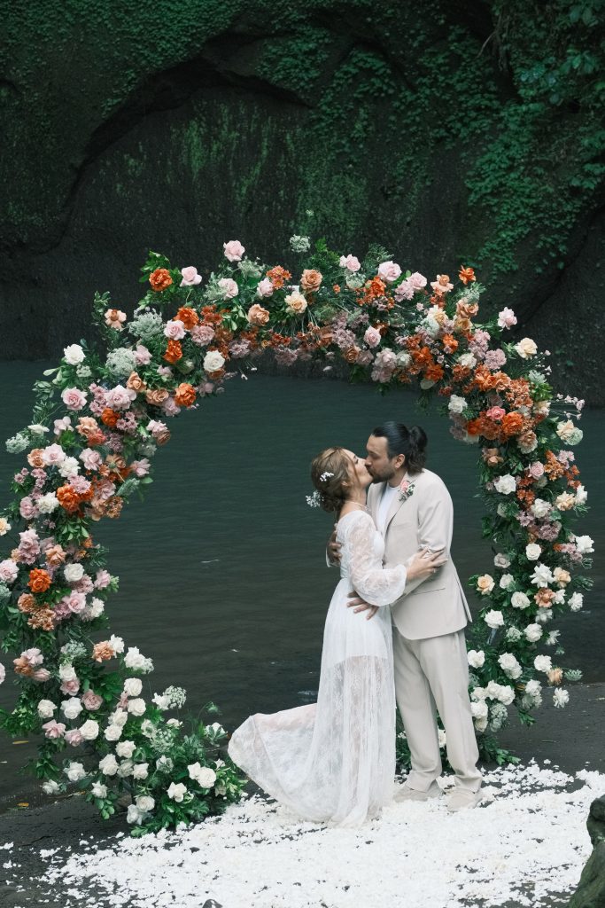 Tibumana-Waterfall-Wedding-Arch-Featuring-Terracotta-Roses-Peach-Chrysanthemums-and-Green-Foliage