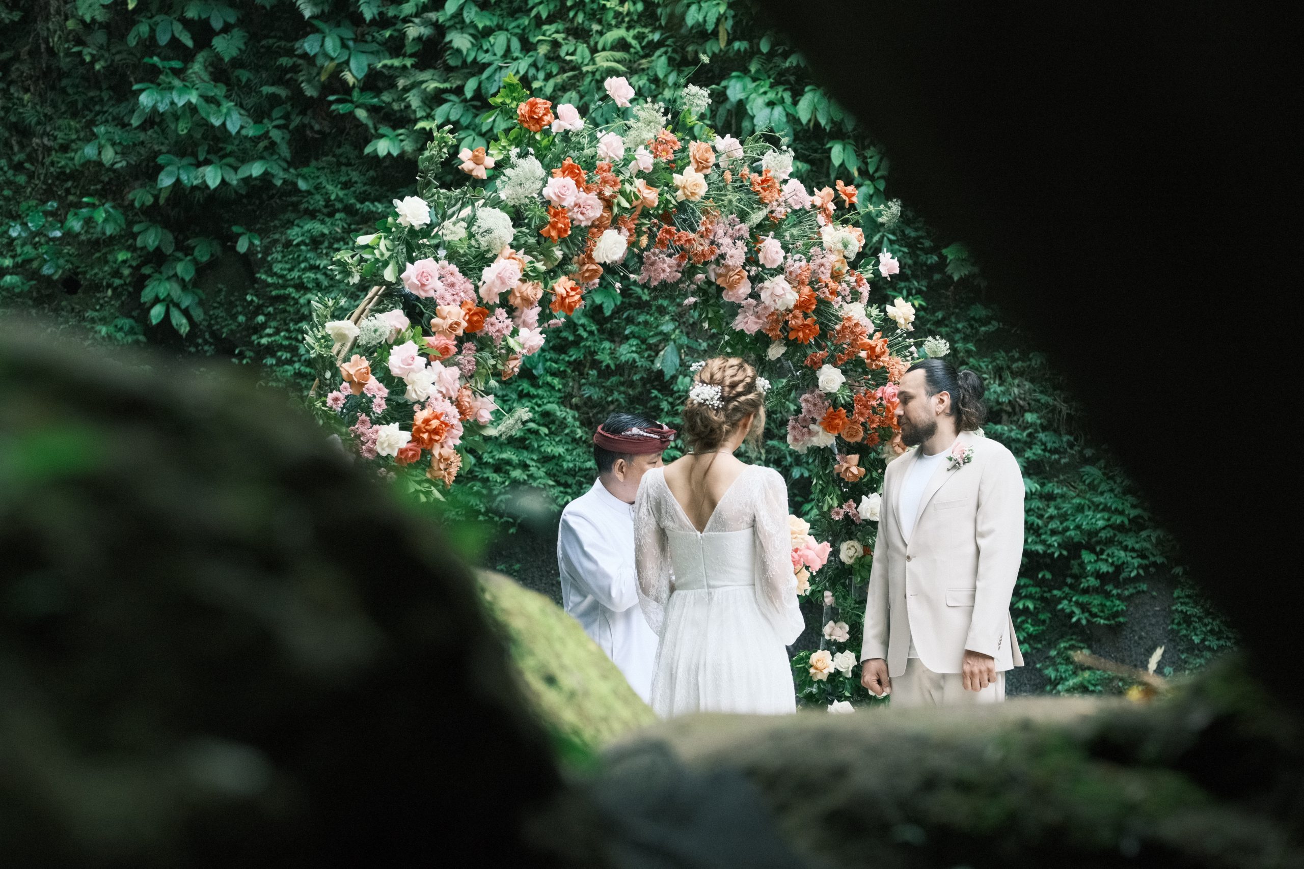 tibumana waterfall wedding arch featuring terracotta roses